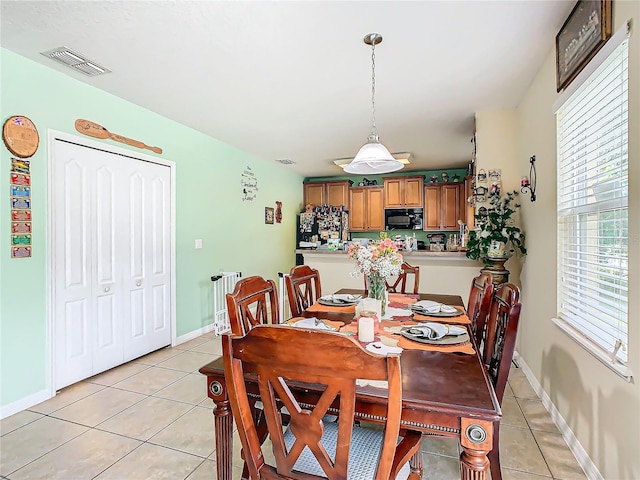 dining area with light tile patterned flooring