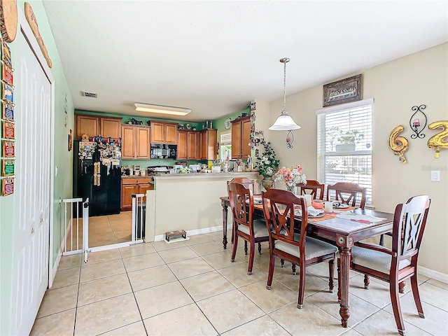 dining area with light tile patterned floors