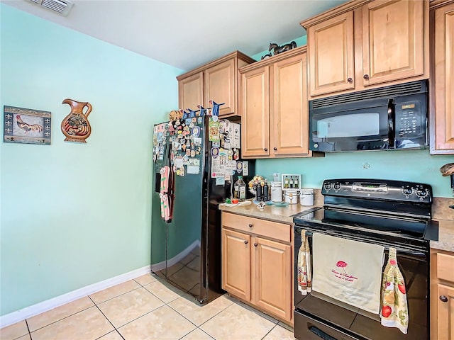 kitchen featuring black appliances, light tile patterned flooring, and light brown cabinets