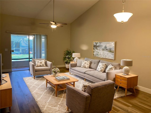 living room with light hardwood / wood-style floors, high vaulted ceiling, and ceiling fan