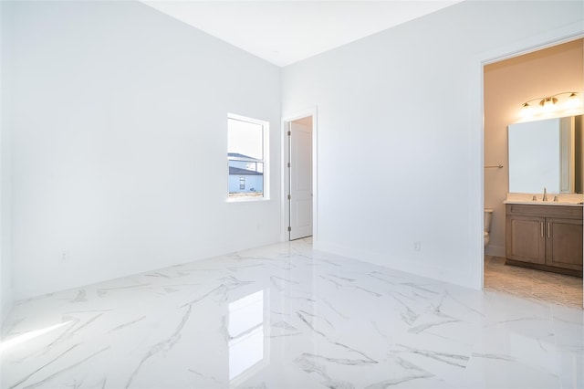 unfurnished room featuring sink