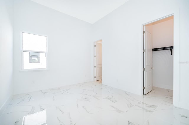 bedroom featuring a spacious closet and a closet