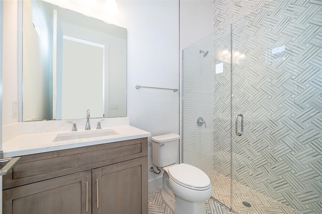 bathroom featuring an enclosed shower, vanity, and toilet