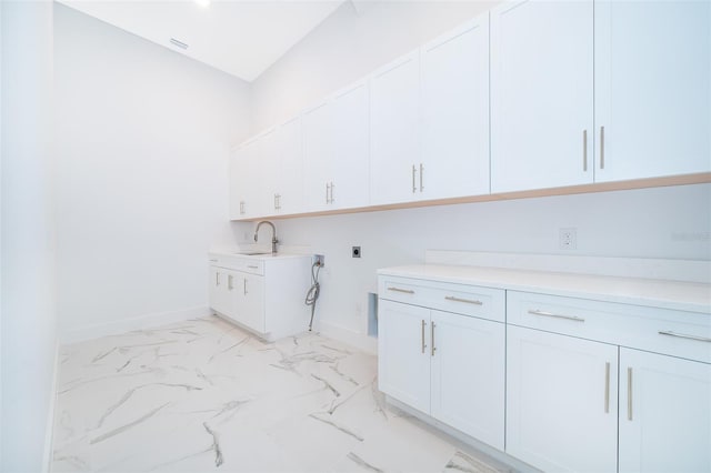 washroom with cabinets and electric dryer hookup