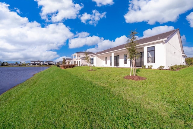 exterior space with a front yard and a water view