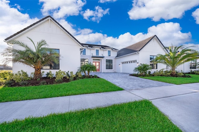 view of front of property with a garage and a front yard