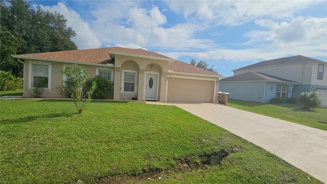 mediterranean / spanish-style home featuring a garage and a front lawn