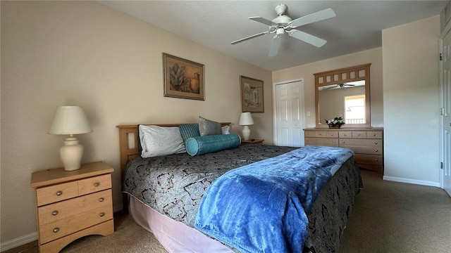 carpeted bedroom with ceiling fan and a closet