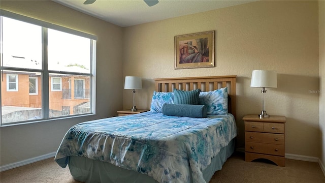 bedroom with ceiling fan and carpet