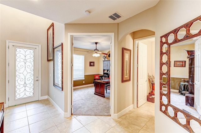 tiled entryway featuring ceiling fan