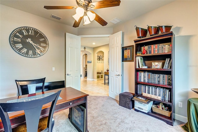 office area with ceiling fan and carpet flooring