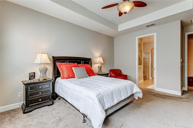 bedroom featuring ceiling fan, ensuite bath, and carpet