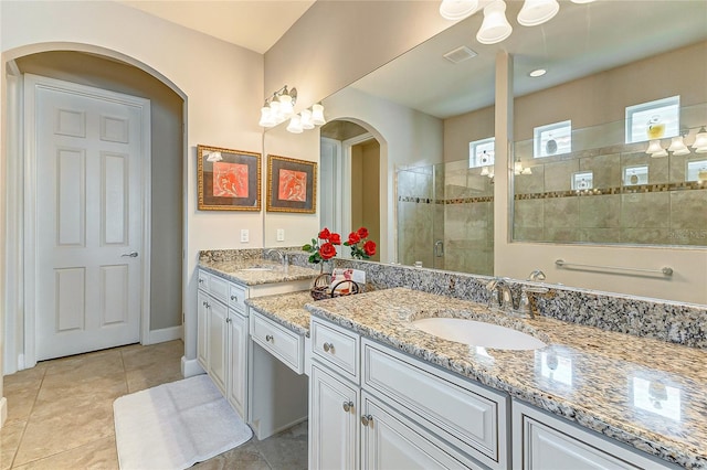 bathroom featuring walk in shower, vanity, and tile patterned flooring