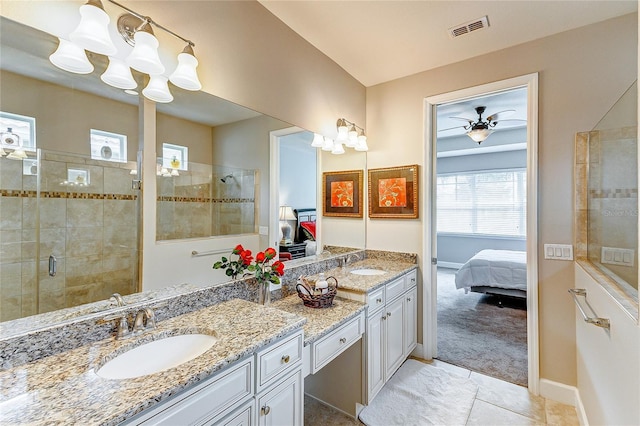 bathroom featuring ceiling fan, a shower with door, and vanity