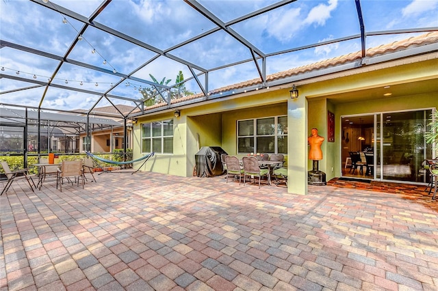 view of patio / terrace with glass enclosure and grilling area