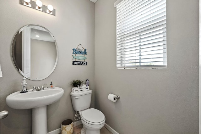 bathroom with sink, tile patterned floors, and toilet