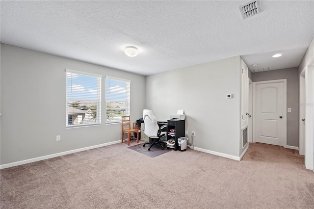 home office featuring a textured ceiling and light colored carpet