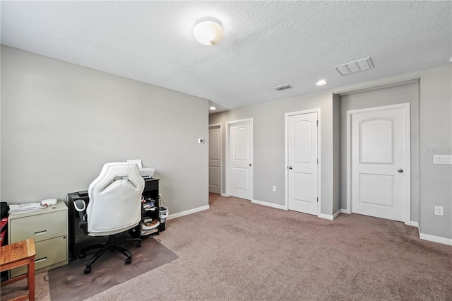 home office featuring a textured ceiling and carpet