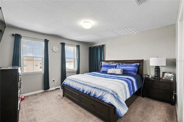 bedroom featuring a textured ceiling and light carpet