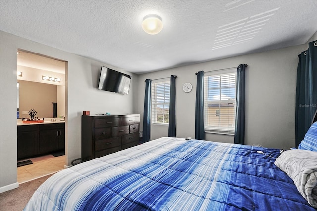 carpeted bedroom featuring sink and connected bathroom