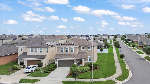 view of front of property featuring a front yard and a garage