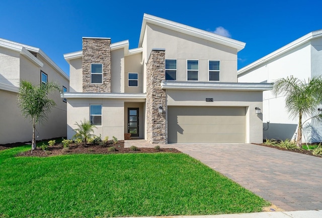 contemporary house featuring a garage and a front lawn