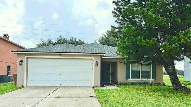 single story home featuring central air condition unit, a front lawn, and a garage