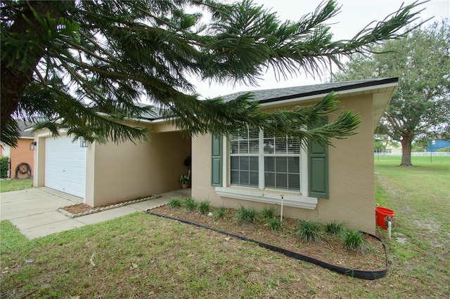 view of property exterior with a yard and a garage