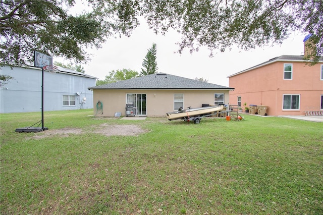 rear view of property featuring a yard and a patio