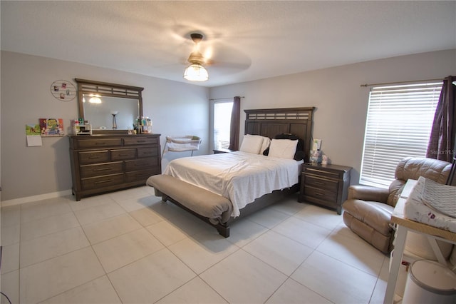 bedroom with ceiling fan and light tile patterned floors