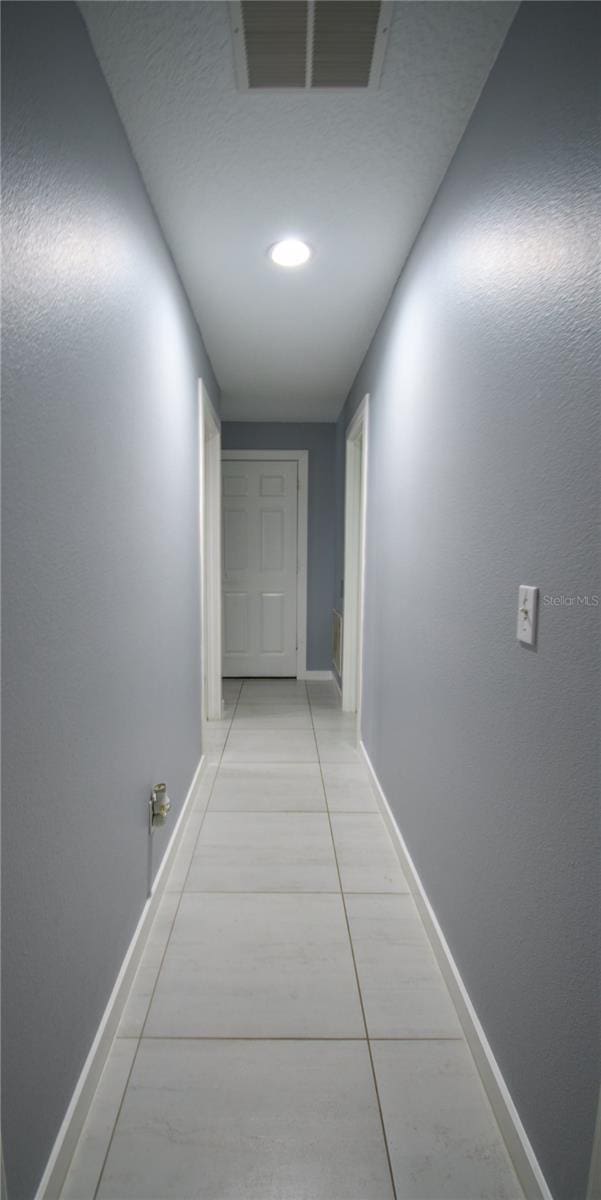 hallway featuring light tile patterned flooring