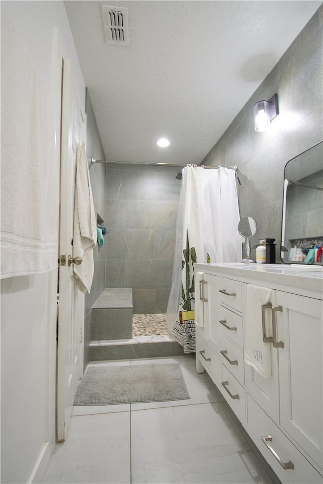 bathroom with vanity and walk in shower