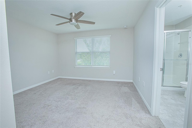 empty room with ceiling fan and light carpet