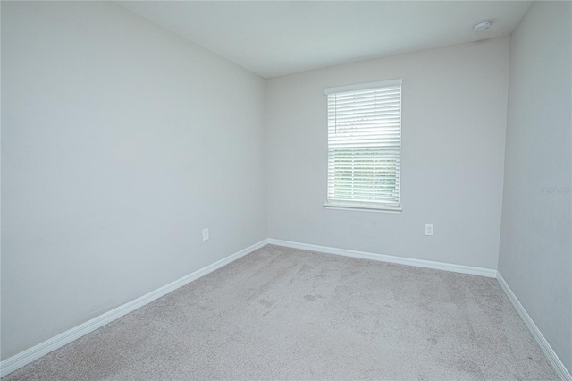 spare room featuring light colored carpet