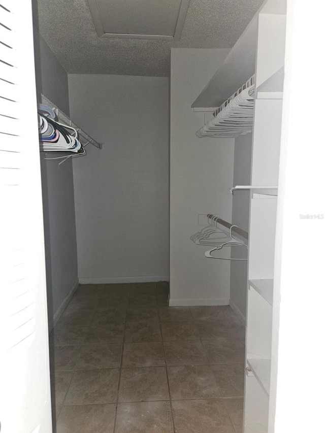 spacious closet with tile patterned floors