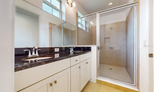 bathroom featuring vanity, tile patterned floors, and a shower with door