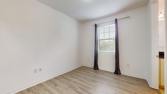 spare room featuring light hardwood / wood-style flooring