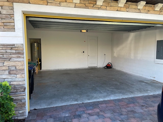 garage featuring water heater and electric panel