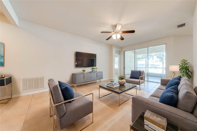 living room with ceiling fan and light hardwood / wood-style floors