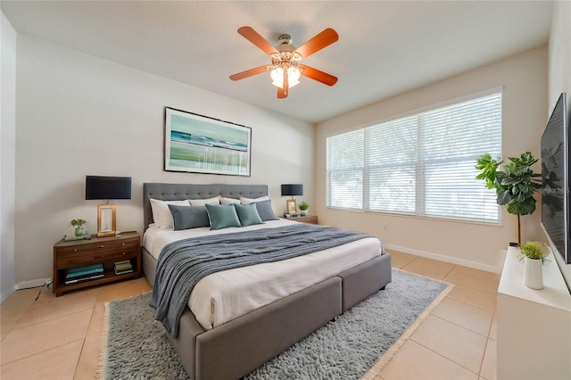 bedroom featuring ceiling fan and light tile patterned floors