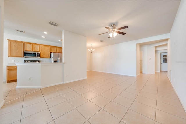 unfurnished living room featuring ceiling fan with notable chandelier and light tile patterned floors