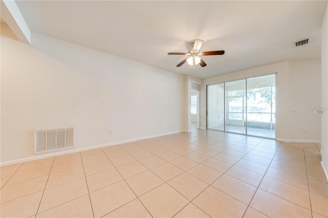 tiled empty room with ceiling fan