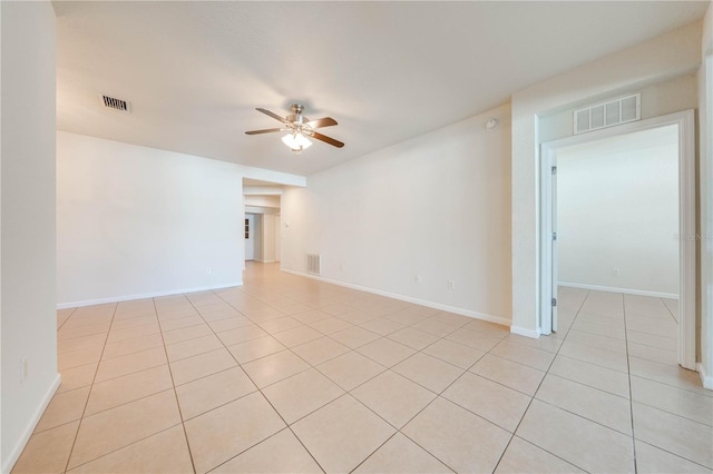 spare room featuring light tile patterned floors and ceiling fan