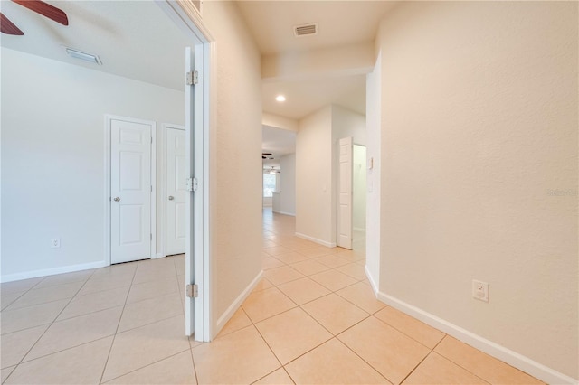 hall with light tile patterned floors