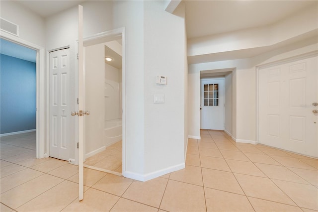 corridor with light tile patterned floors