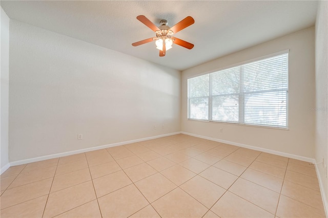 unfurnished room with light tile patterned floors and ceiling fan