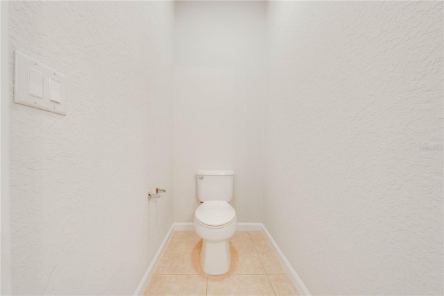 bathroom featuring tile patterned flooring and toilet