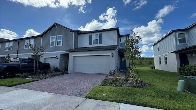 view of front of property featuring a garage and a front lawn