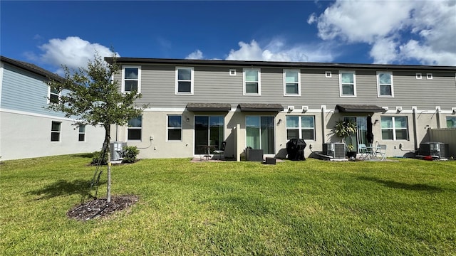 back of property with a lawn, a pergola, and central AC unit