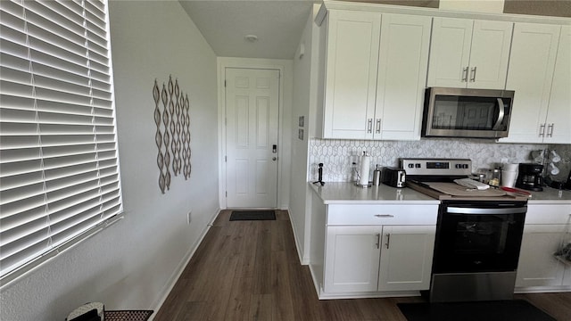 kitchen featuring stainless steel appliances, dark hardwood / wood-style flooring, tasteful backsplash, and white cabinetry